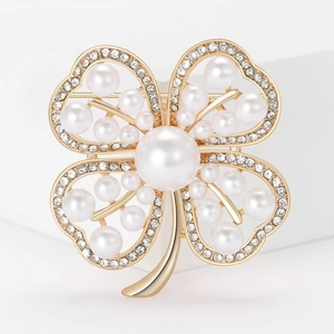 Elegant four-leaf clover brooch with gold-tone metal base, white pearls, and clear crystals