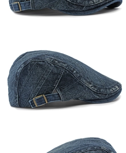 Detailed view of the side adjustable bronze buckle on dark blue washed denim flat cap