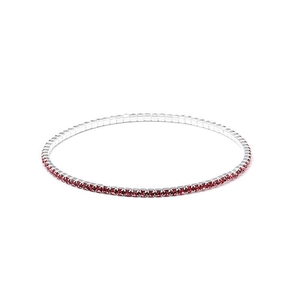 Detail view of 2.0mm silver elastic tennis bracelet featuring round red crystal stones