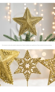 Detail of gold glitter Christmas tree topper star and hollow snowflake hanging ornaments