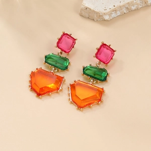 Bohemian colorful geometric drop earrings with pink and green resin gems on warm stone
