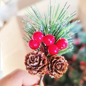 Close-up of Christmas pick with red berries, green pine needles, and natural pine cones