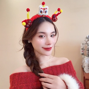 Close-up of red plush headband with 3D white lion dance and festive embroidery