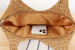 Interior view of woven paper rope tote bag showing satin lining and spacious capacity
