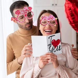 Valentine's Day party glasses with I Love You and Kiss me heart shaped paper frames
