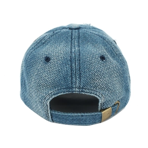 Detail of vintage denim baseball cap back with distressed texture and metal buckle