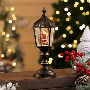 Close-up of vintage bronze Christmas lantern with Santa scene and snowy light effects