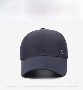 Close-up of Navy Blue Baseball Cap showing silver S letter and reinforced brim stitching