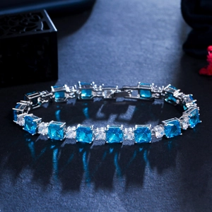 Macro shot of geometric square blue zircon and round diamonds on silver plated bracelet