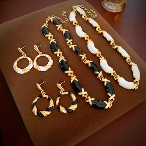 Detailed view of vintage twisted geometric enamel necklace and earring sets in gold finish