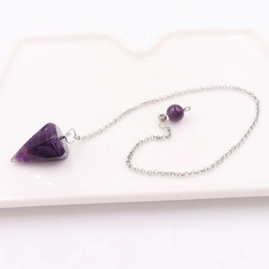 Macro detail of natural amethyst pendulum pendant with hexagonal crystal and silver chain