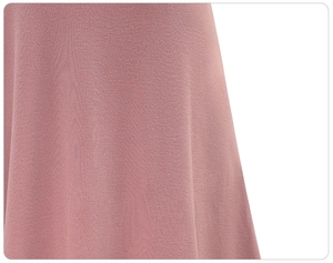 Detailed close-up of soft dusty rose fabric texture with elegant vertical drape