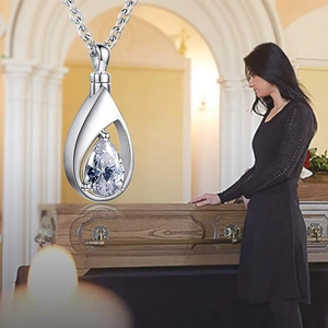 Detailed view of silver teardrop cremation pendant for ashes with crystal zircon