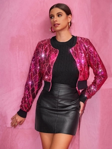 Pink sequin cropped jacket styled with black leather skirt on model in front of pink wall