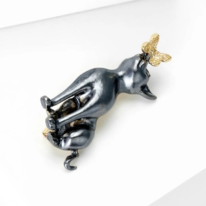 Cute black grey alloy cat brooch with a golden butterfly detail on a white background