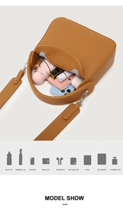 Top view of large brown leather bag showing spacious interior for iPad and umbrella