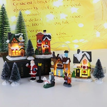 Christmas village miniature set with glowing resin houses, Santa, and reindeer display