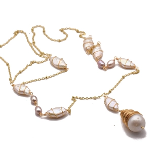 Elegant baroque pearl necklace with gold wire wrapping and lavender accents on white backdrop