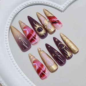 Deep purple stiletto press-on nails with gold celestial sun and moon hand-painted patterns