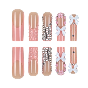Pink coffin press-on nails with 3D bows, flowers, and silver rhinestones on white background