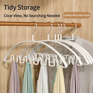 Space-saving white wave hanger for scarves and camisoles in an organized wooden wardrobe