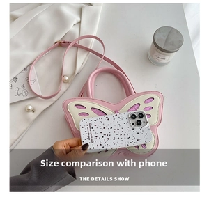 Pink butterfly shaped handbag with pearl strap and purple glitter detail macro view