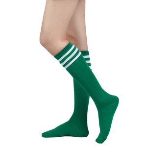 Detail of green knee-high socks with three white stripes and elastic ribbed cuff