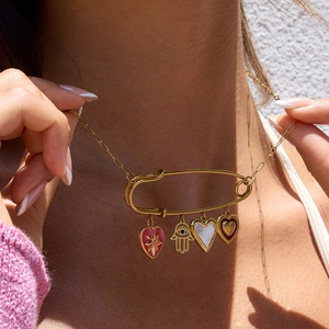 18K gold plated necklace featuring a safety pin pendant with four diverse heart charms