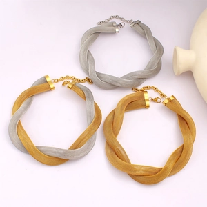 Detail of twisted mesh link necklace with lobster clasp in gold and silver finishes