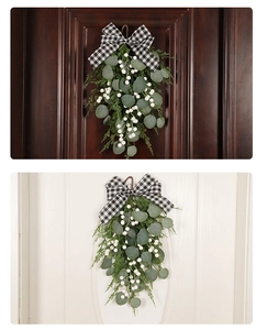 Eucalyptus Christmas swag with white berries and plaid bow on red and white doors