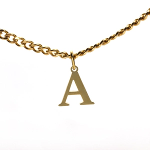 Macro shot of 18K gold plated necklace featuring a polished letter A initial pendant