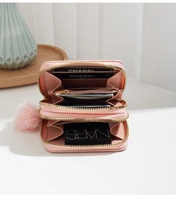 Detail view of the open pink quilted double-layer wallet with card slots and coin pocket