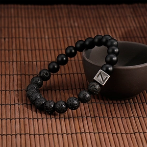 Detail of beaded bracelet with black volcanic lava stones and silver Z letter bead