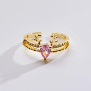 Golden reindeer antler open ring with a pink teardrop gemstone and sparkling diamonds
