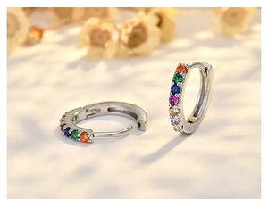 Close-up of silver hoop earrings with multicolored rainbow cubic zirconia gemstones