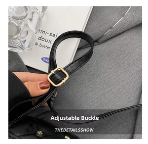 Detail of adjustable gold buckle on high-quality black faux leather handbag strap