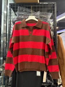 Detail of red and brown striped knit sweater featuring a polo V-neckline and collar