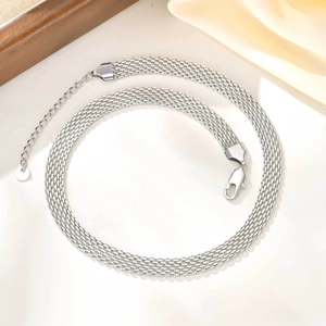 Detail of silver mesh necklace showing lobster clasp and extension chain with metal tag