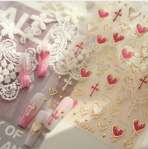 Detailed view of M-1033 heart and cross nail stickers with gold embossed finish