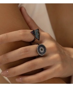 Close-up of S925 silver rings with evil eye and triangle crystal stones on finger