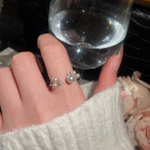 Detail of French vintage open ring featuring elegant pearls and sparkling zircon accents