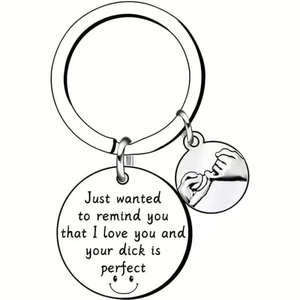 Macro detail of polished stainless steel keychain with custom engraved text and pinky swear icon