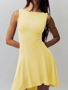 Detail of slim-fit sleeveless yellow dress with cinched waist and pleated flared skirt