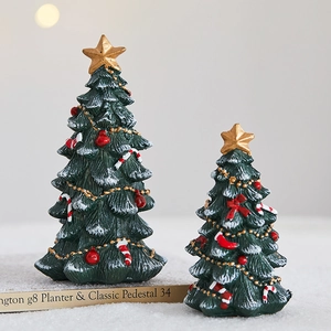 Mini resin Christmas trees with red ornaments and gold stars for holiday table decor