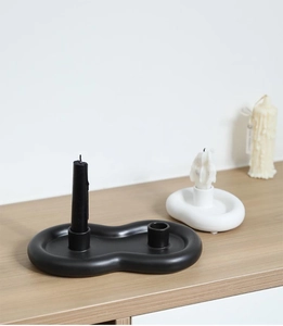 Modern minimalist ceramic candle holder set with matte finish on light wood surface