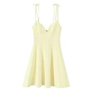 Detail of light yellow poplin A-line dress with tie-up straps and structured seams