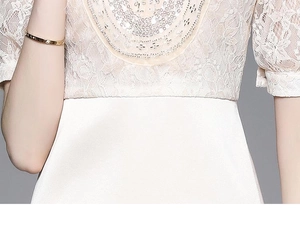 Close-up of elegant lace patchwork and sequin embroidery on cream satin dress