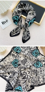 Detail view of square silk scarf with geometric diamond patterns and floral textures