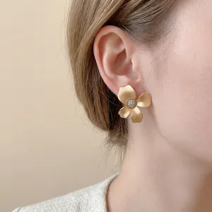 Elegant matte gold flower stud earrings with sparkling cubic zirconia center for women
