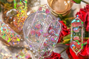 Detailed macro of laser embossed floral bookmarks with iridescent rose motifs on PVC